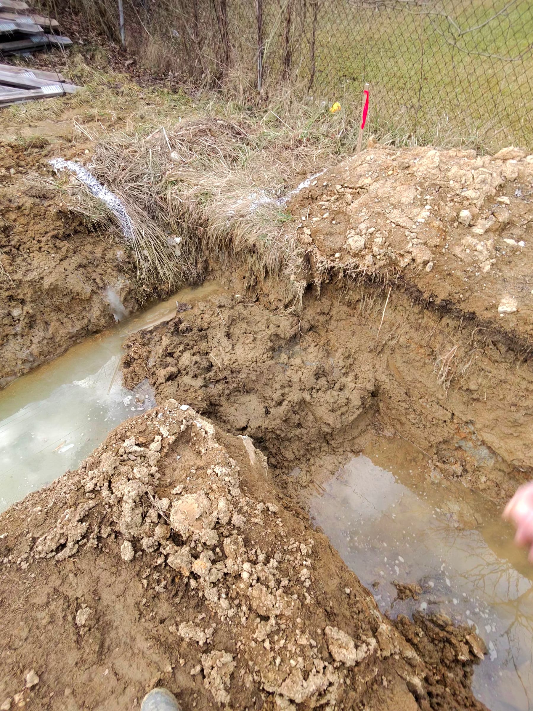 Excavated footer trench at a corner of the house layout