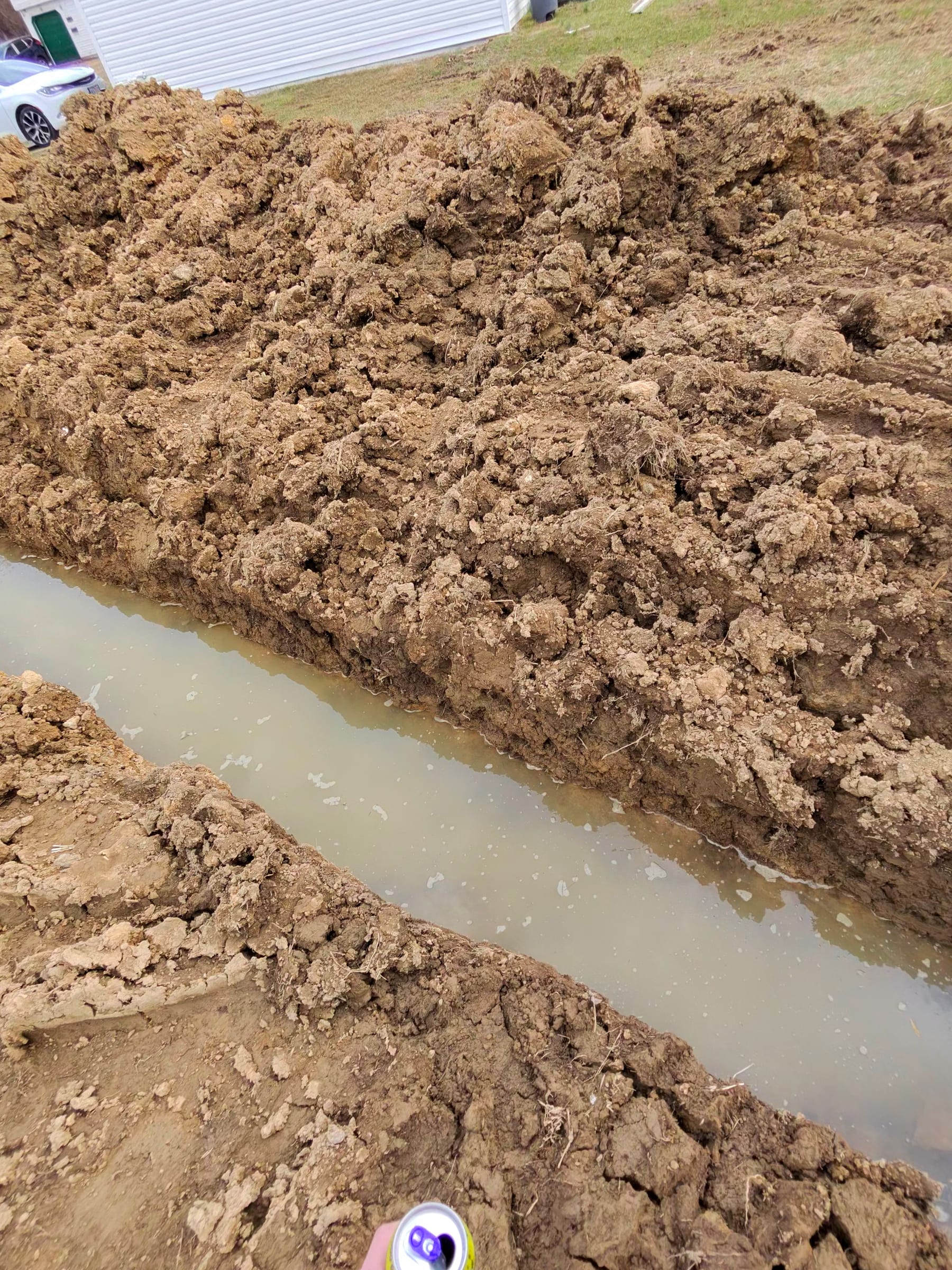 Close view of the footer trench and excavated soil