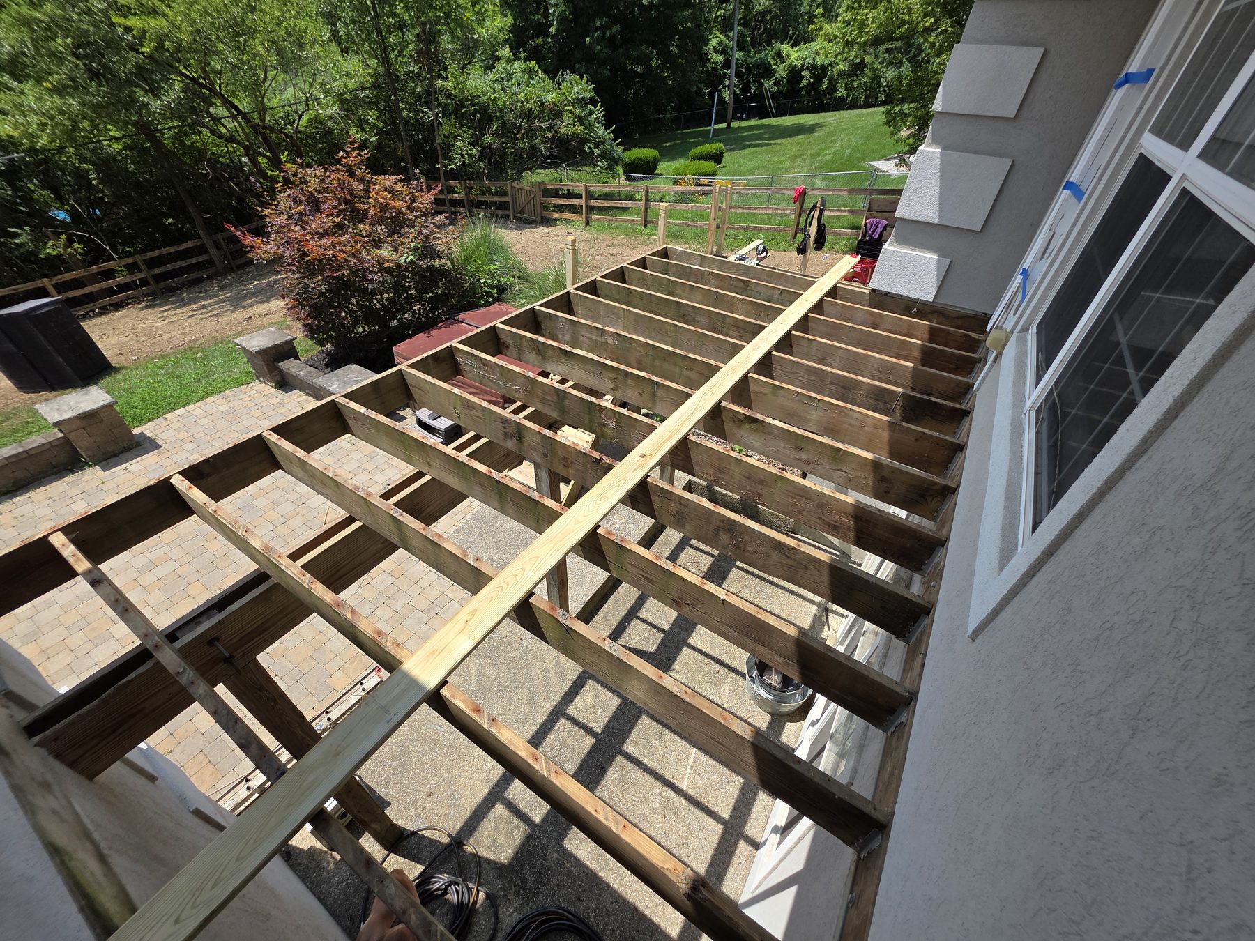 Open joists and framing prepared for new deck boards