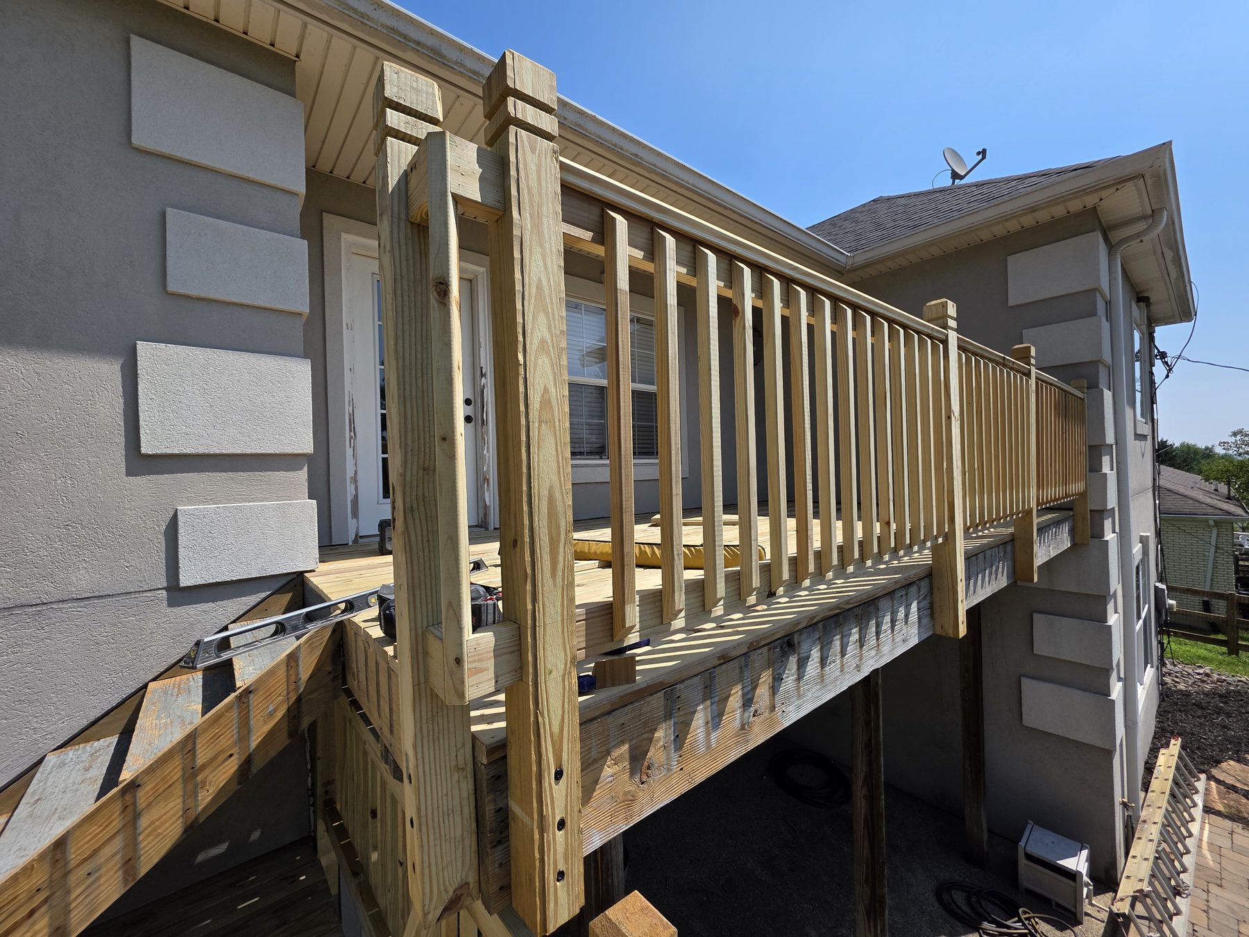 New deck boards and railing installation underway