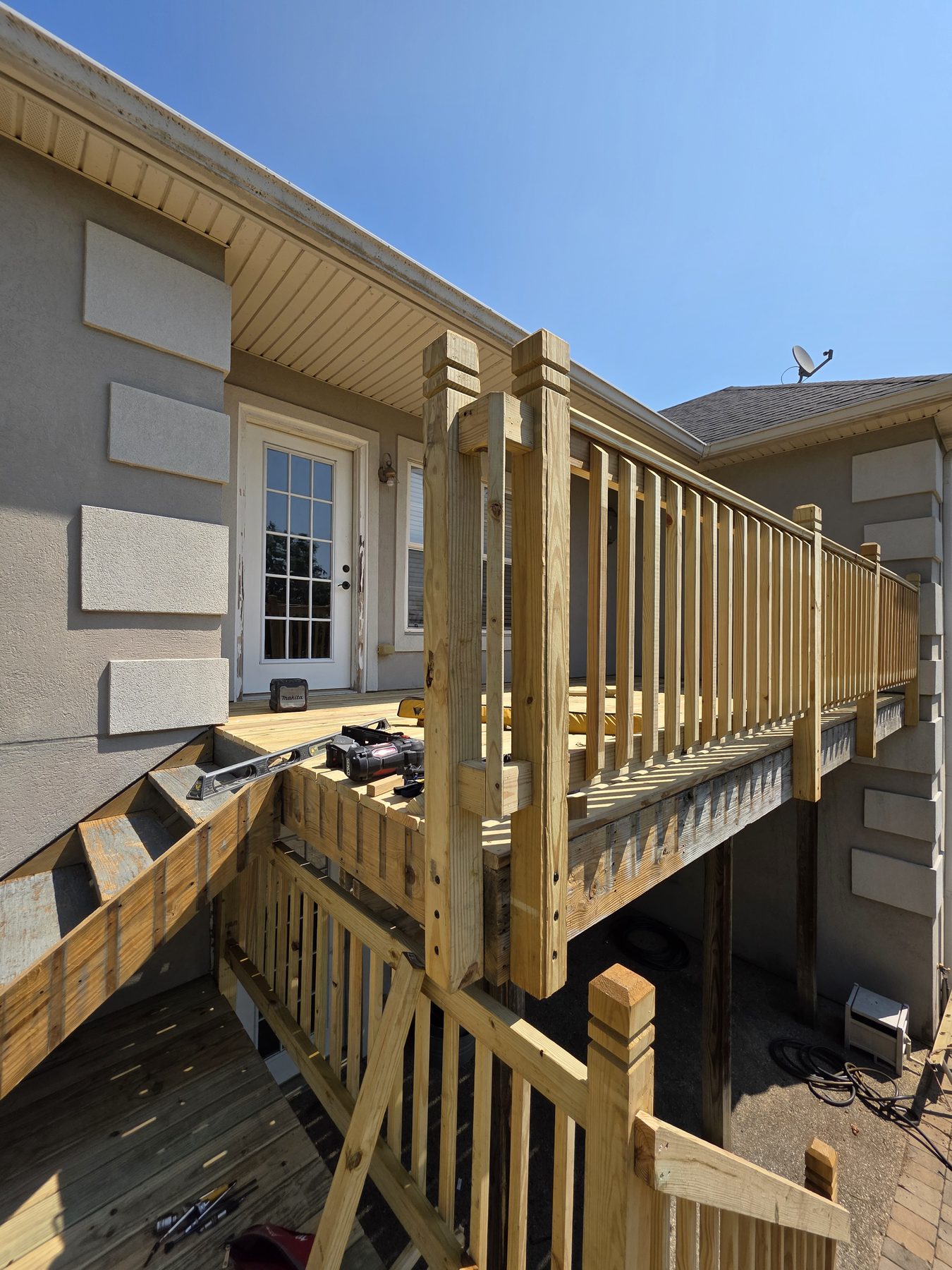 Pressure-treated railing taking shape on the upper deck