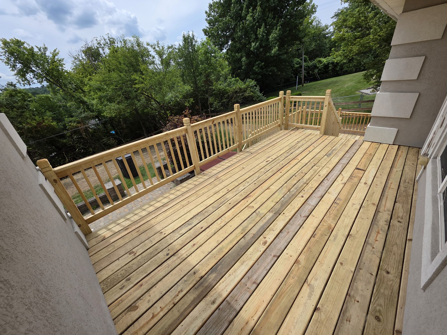 New pressure-treated decking installed across the upper deck