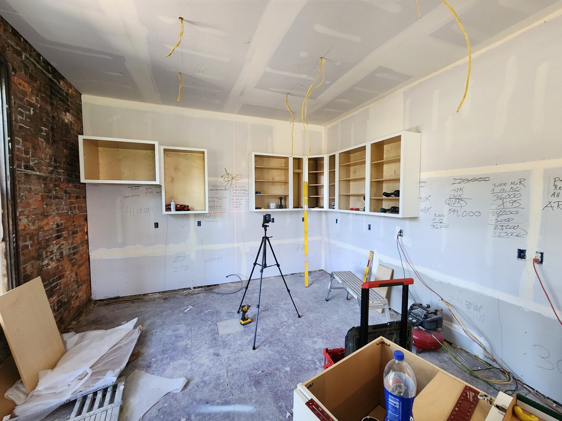 White upper cabinet boxes positioned along the kitchen walls