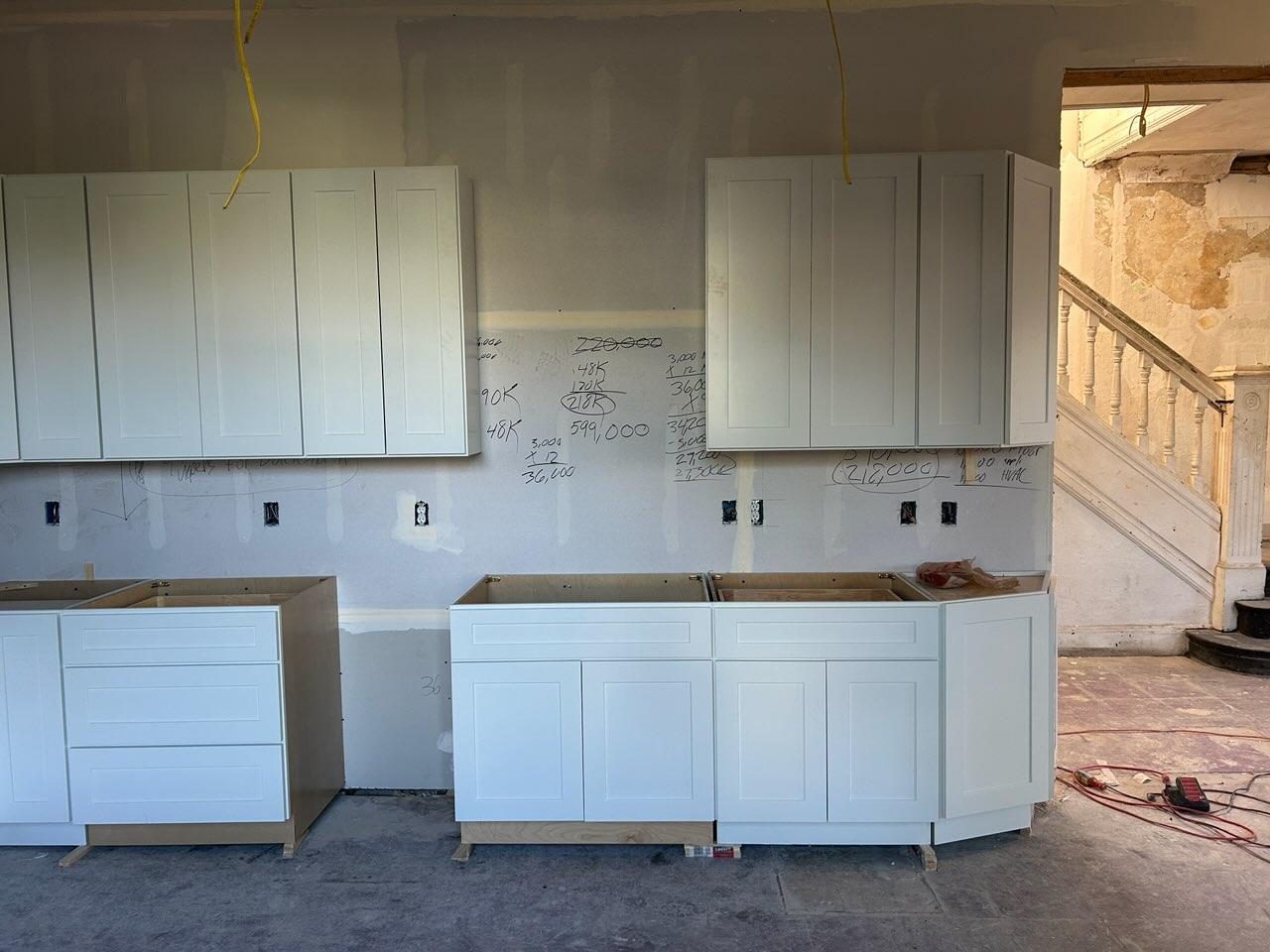 Aligned white shaker upper and base cabinet run