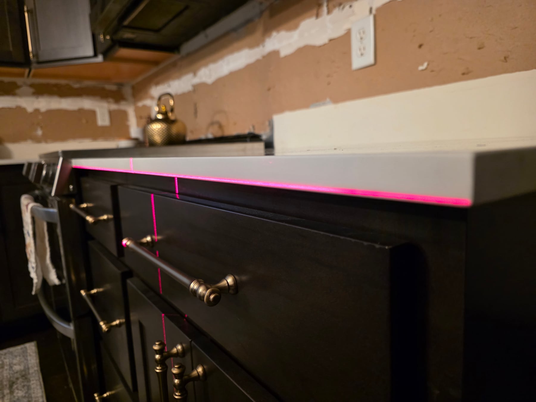 Laser line used to verify counter and cabinet alignment