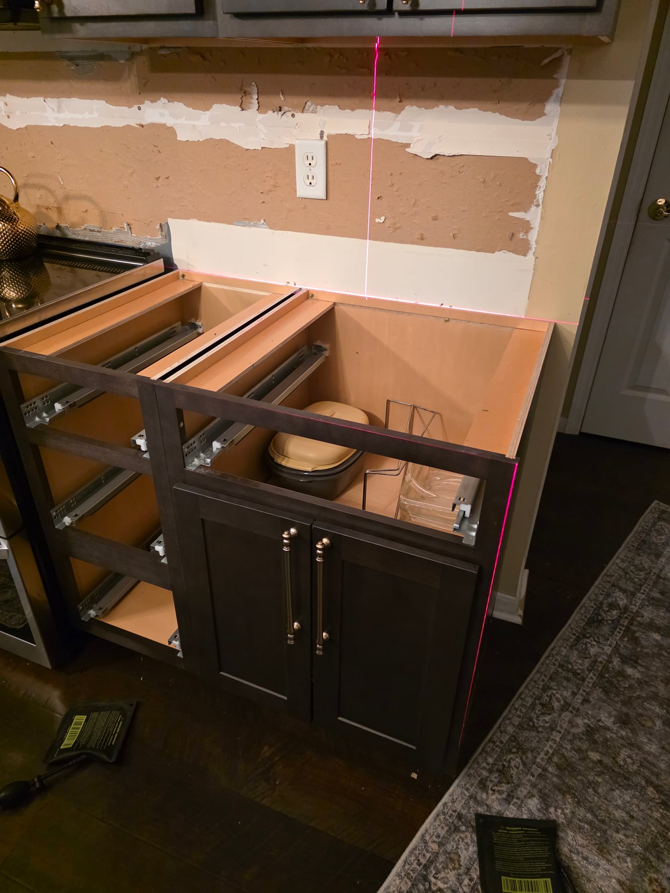 Laser lines checking cabinet-box alignment before counter installation