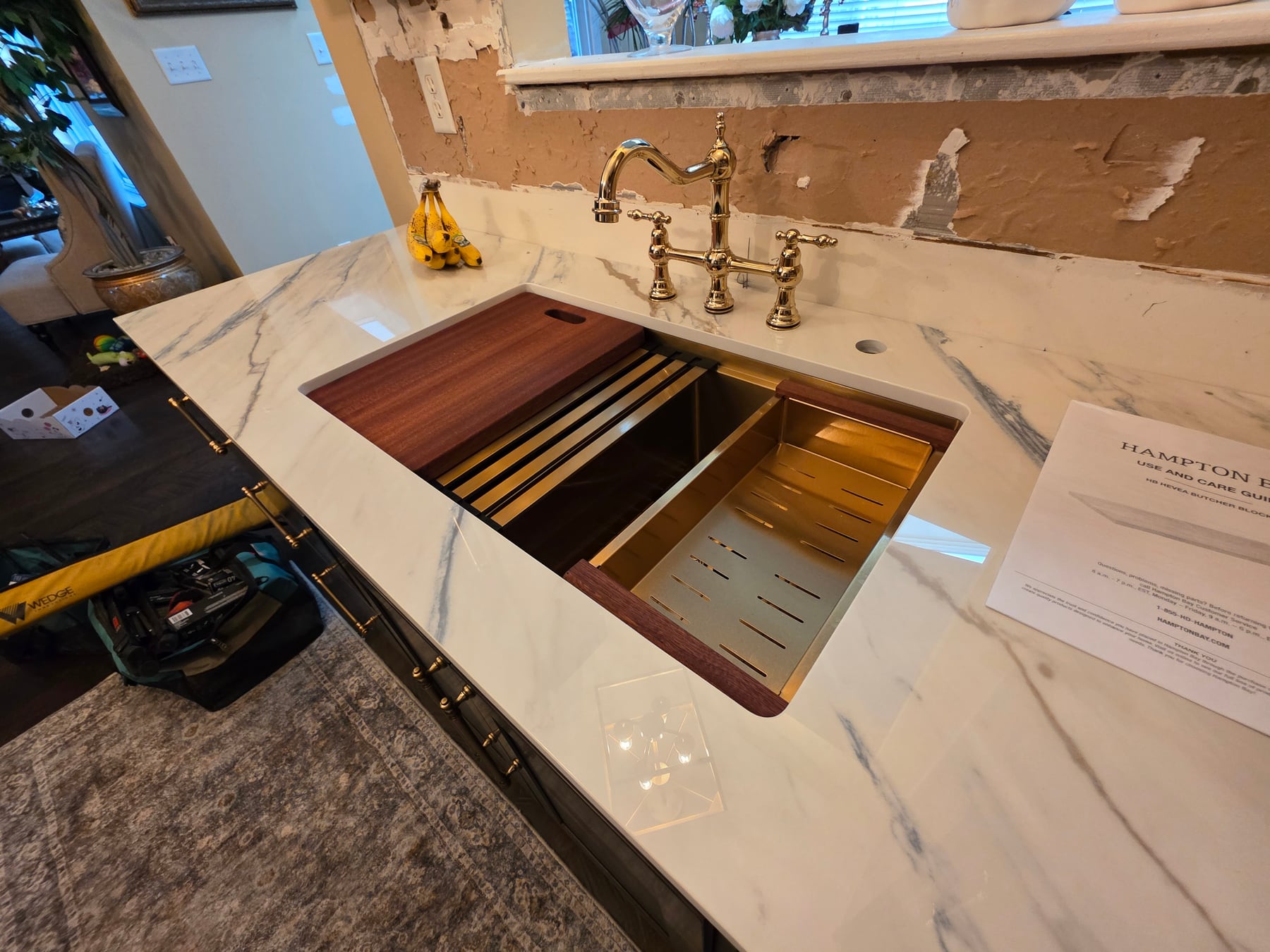 Brass workstation sink with fitted cutting board and accessories