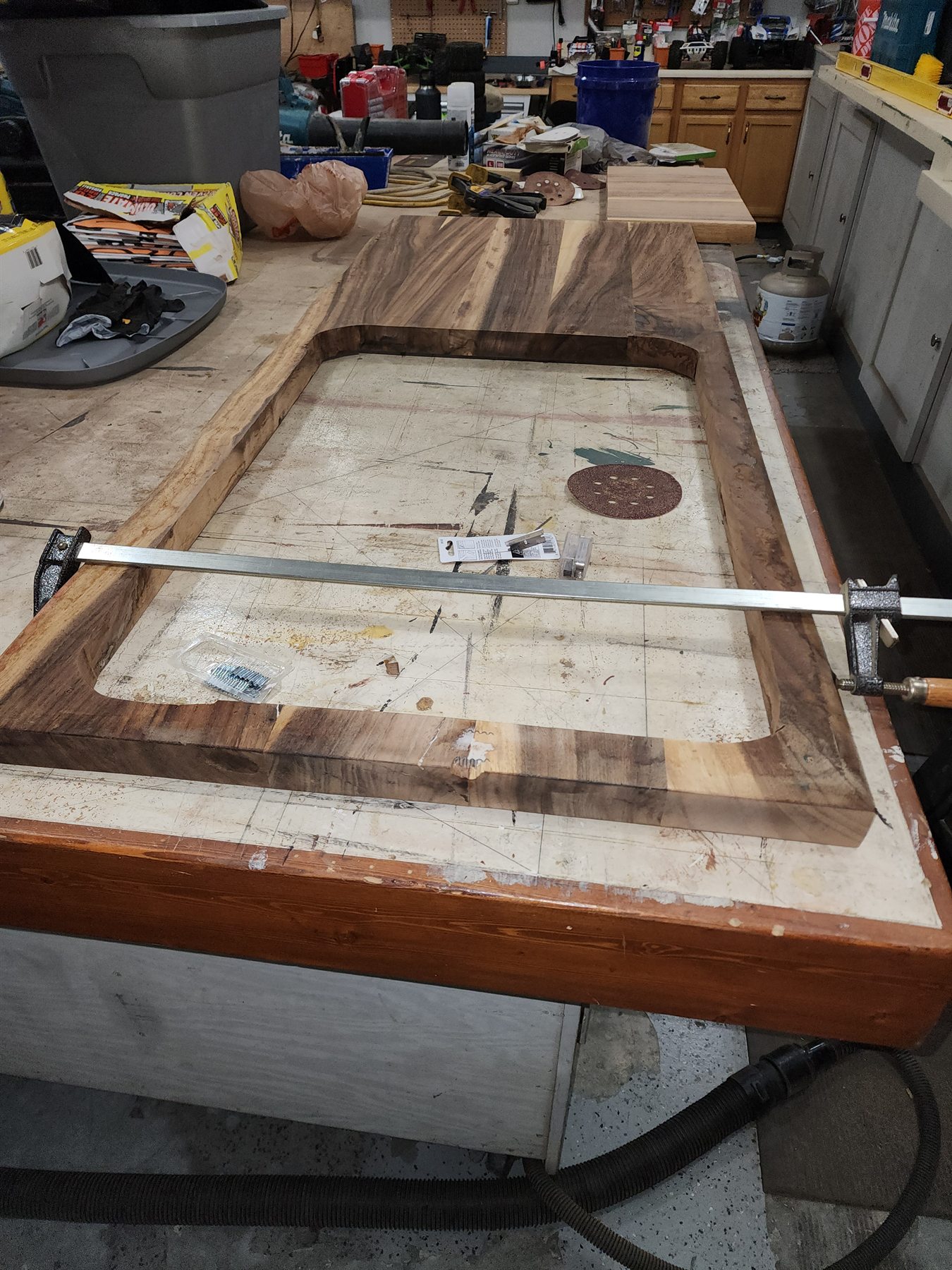 Reassembled live-edge countertop clamped on a workshop bench