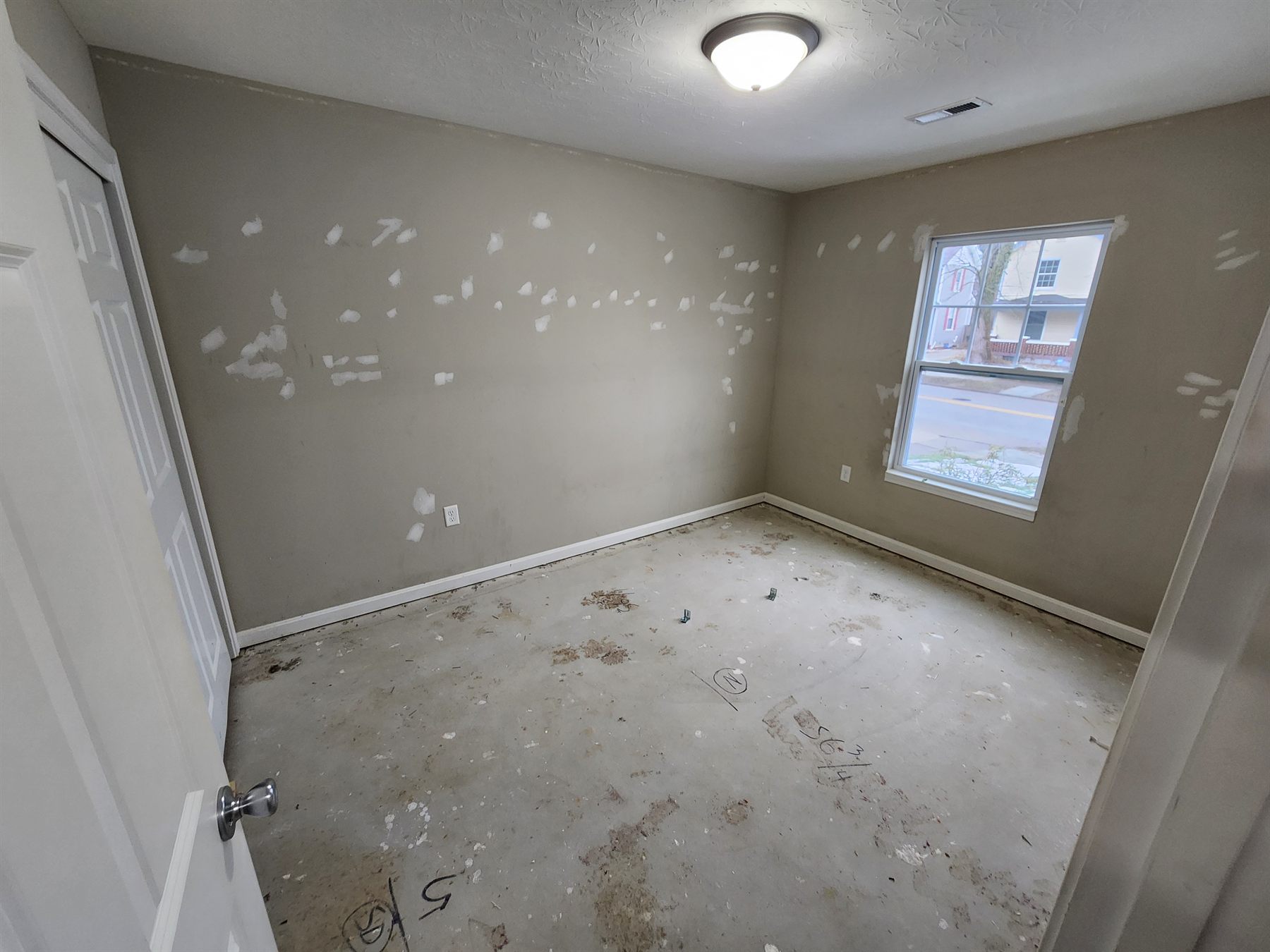 Patched bedroom walls prepared for paint